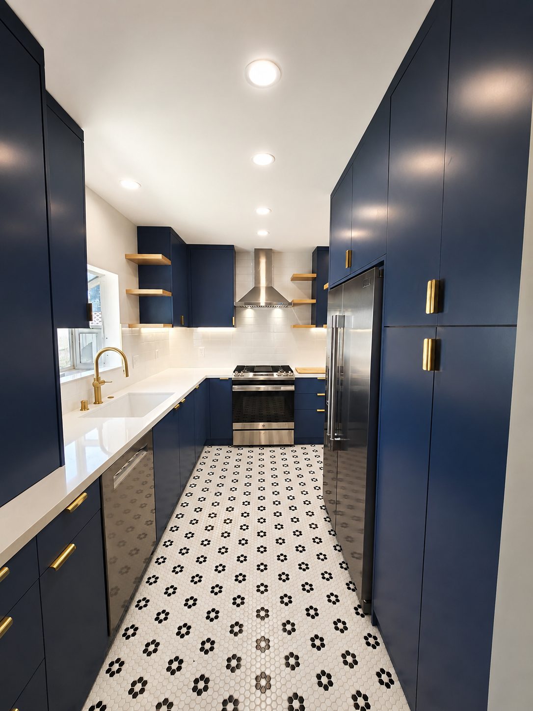 Navy blue and gold accent galley kitchen with patterned tile floor in Los Feliz