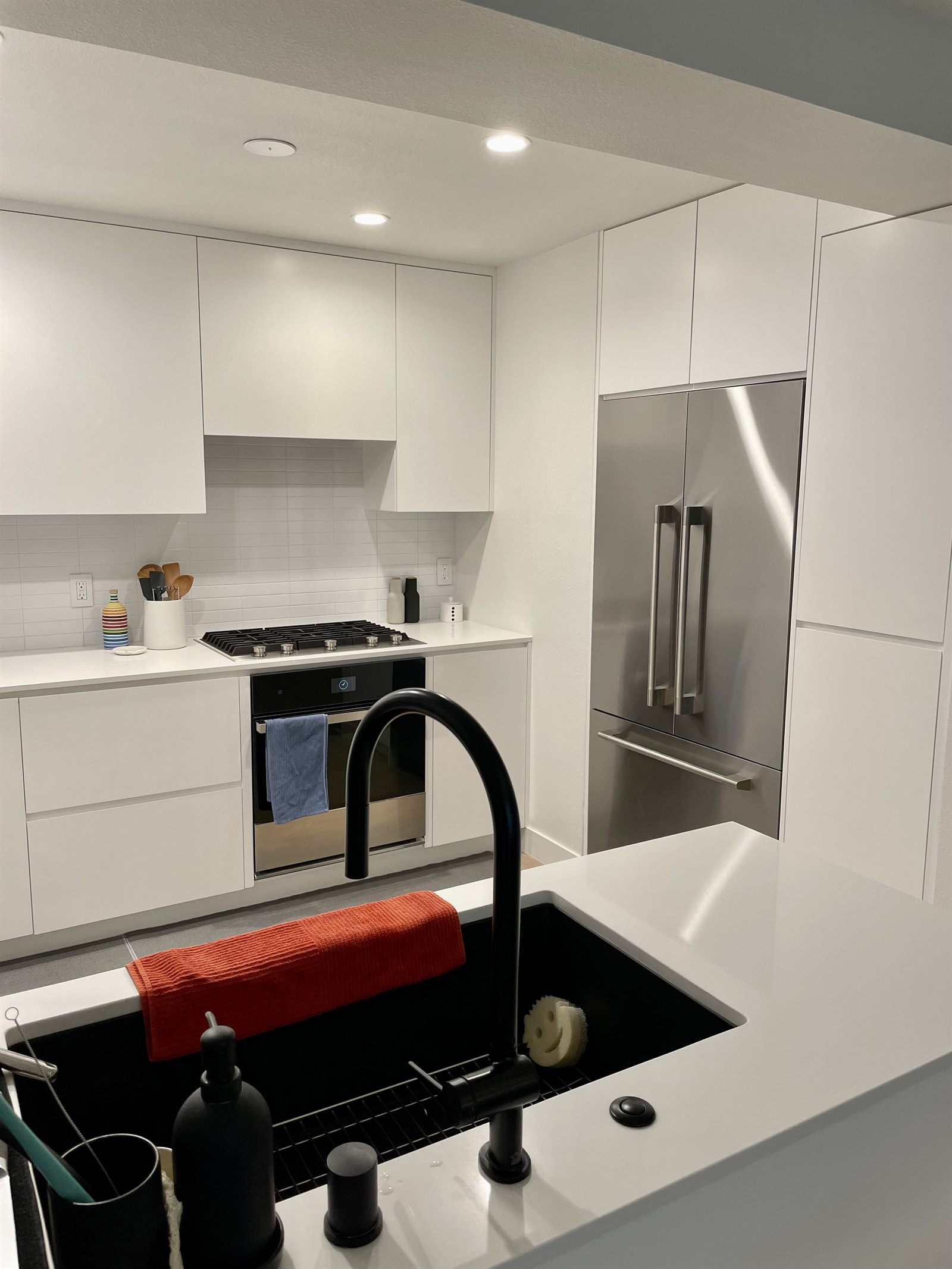 After: modern white flat-door minimalist kitchen, refrigerator view