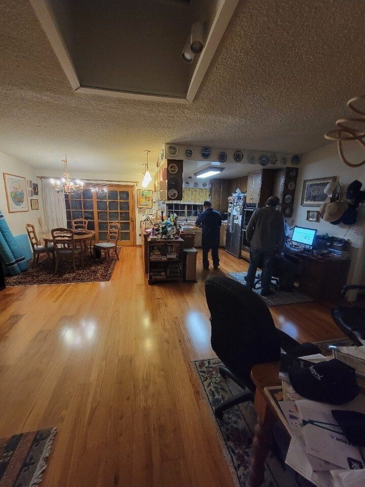 Before: original Weiner kitchen with dated oak cabinets and dropped ceiling, open to dining